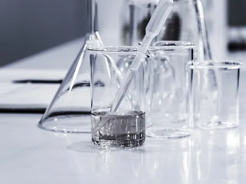 Glass beakers and a test pipette used for measuring water chemistry.
