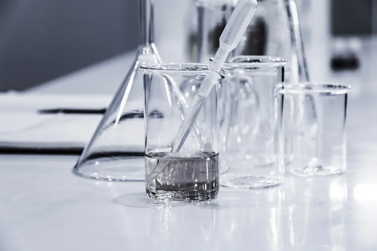 Glass beakers and a test pipette used for measuring water chemistry.